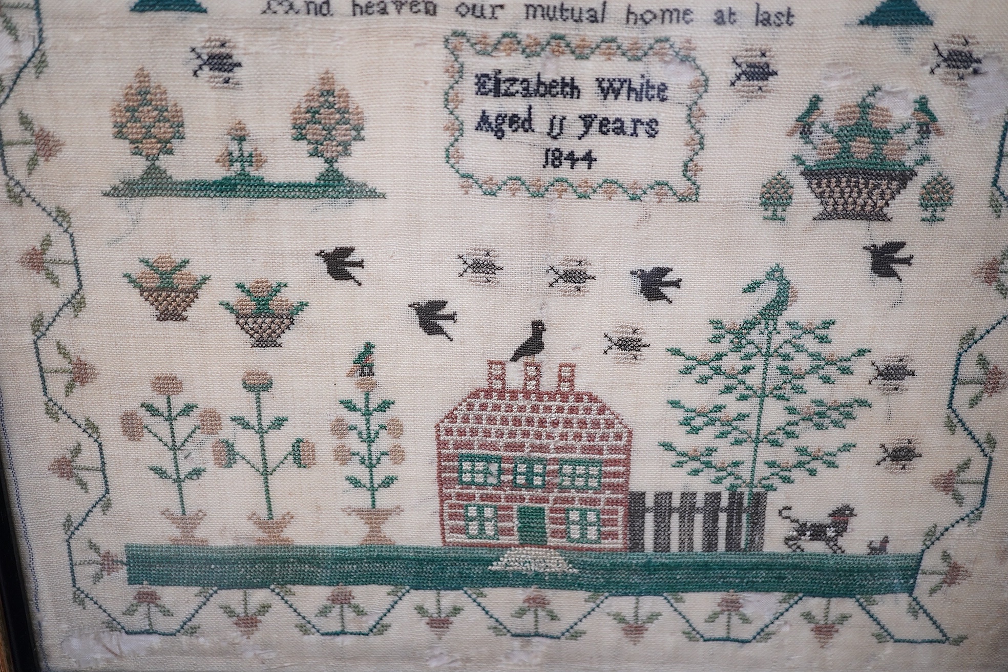 Two mid 19th century samplers worked by Elizabeth White, one dated 1842 aged 8 years, the other 1844 aged 11 years, both worked with a country scene of a house, birds, dogs and trees, the earlier sampler with a top panel